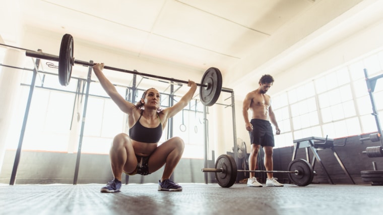 people in gym doing crossfit exercise