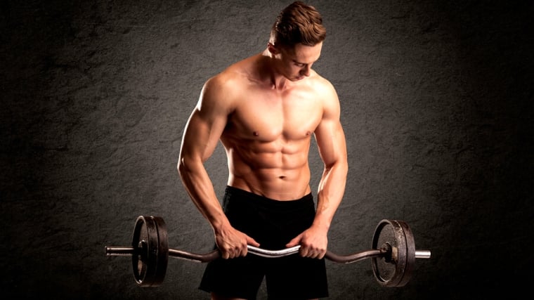 A person doing a reverse biceps curl, with arms not fully extended.