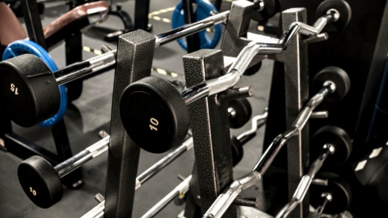 Barbells on a rack.