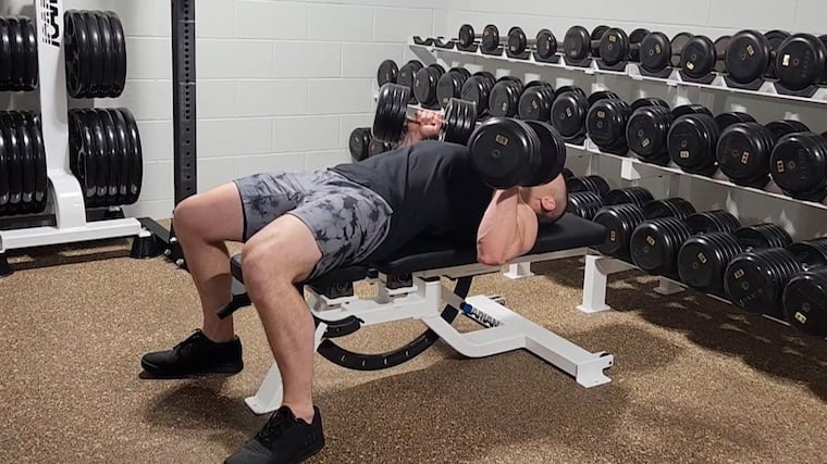 Dr. Merrick Lincoln performing dumbbell hex press