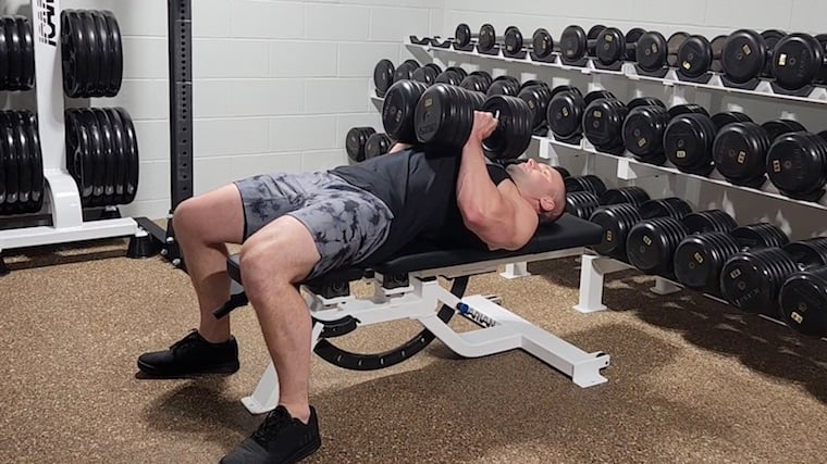 Dr. Merrick Lincoln performing dumbbell hex press