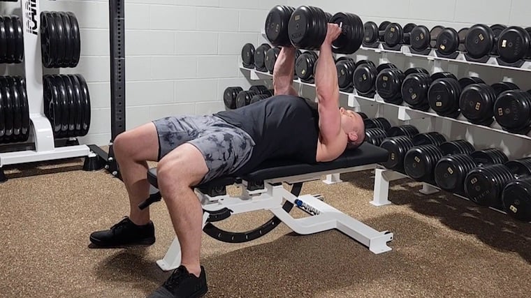 Dr. Merrick Lincoln performing dumbbell hex press